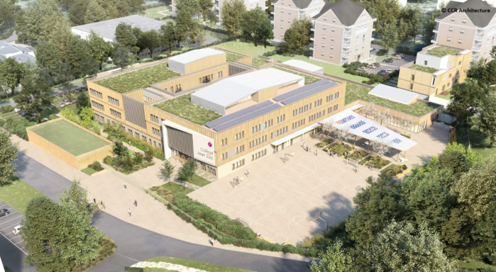 Vue aérienne d'un bâtiment moderne avec un toit végétalisé et un espace extérieur.